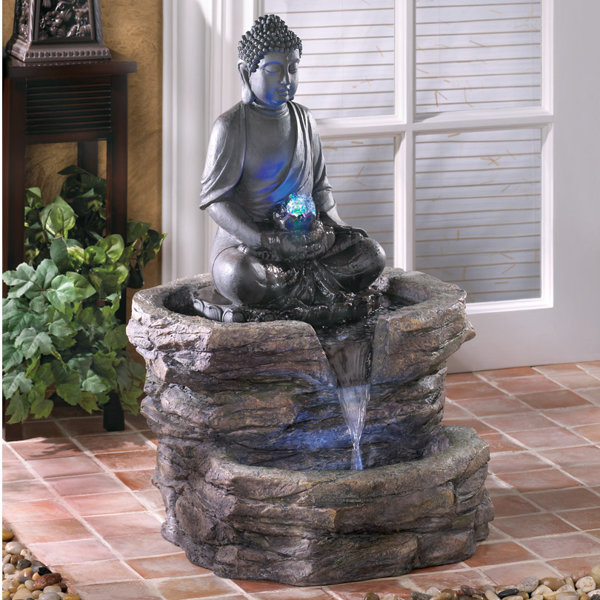 resin meditating buddha on column patio fountain with led light